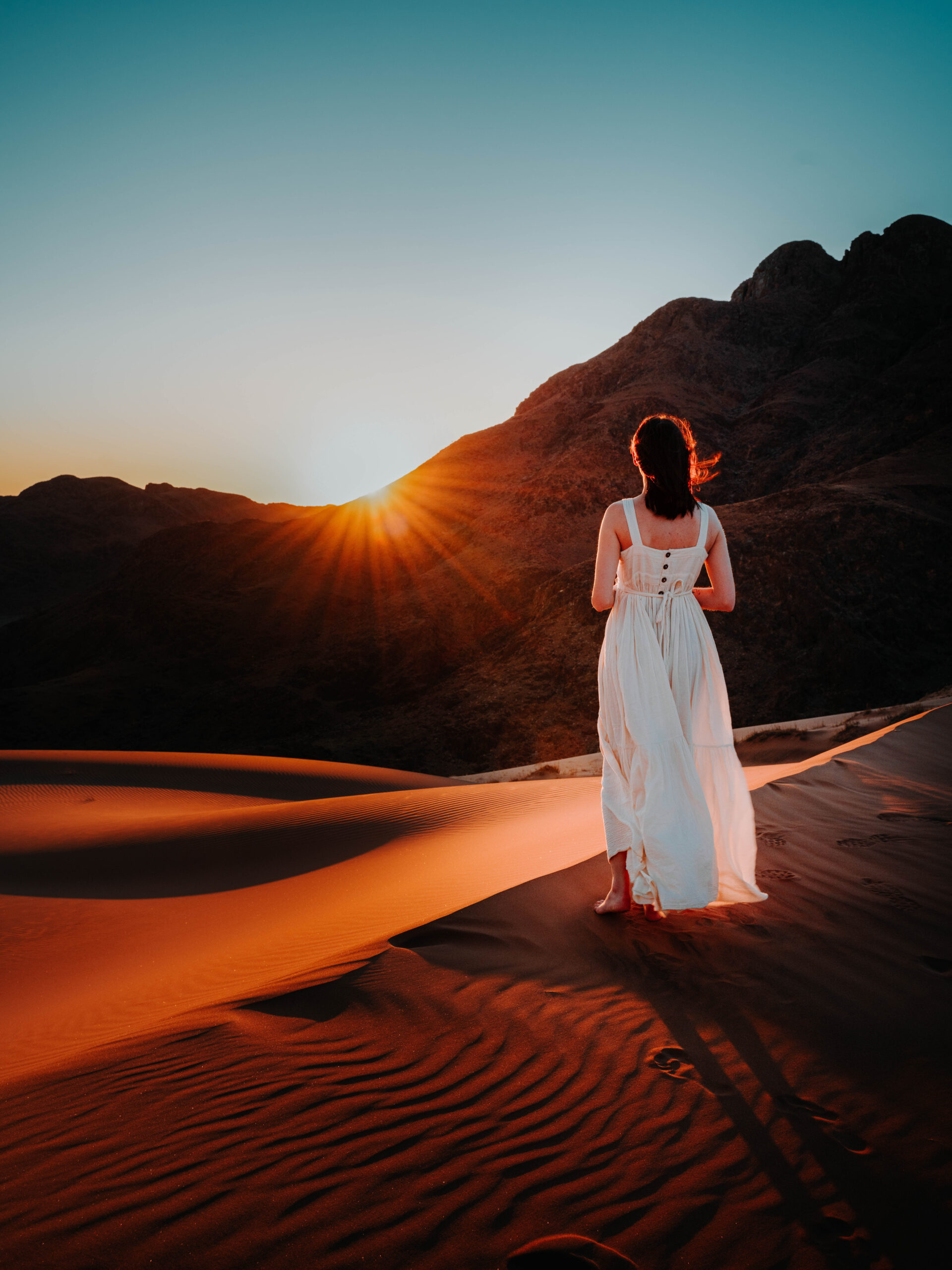 girl standing on dunes in namibia at sunset | wander to here